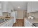 The kitchen layout features a fridge, cabinets, and adjacent door leading to another room at 1112 Mark St, Raleigh, NC 27601