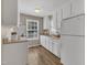 Well-lit kitchen with bright white cabinets, and modern appliances at 1112 Mark St, Raleigh, NC 27601