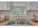 The kitchen sink area is illuminated by natural light from the nearby window at 1112 Mark St, Raleigh, NC 27601