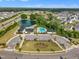 Community amenities featuring a pond, clubhouse, and swimming pool with ample parking at 112 Serenata Dr, Holly Springs, NC 27540