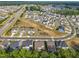 Sprawling suburban community with modern homes, lush landscaping, and convenient street access at 112 Serenata Dr, Holly Springs, NC 27540