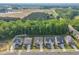 New construction homes with well-manicured lawns in a scenic community with a pond and wooded area at 112 Serenata Dr, Holly Springs, NC 27540
