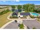Community clubhouse and pool featuring modern architecture near a serene pond and residential homes at 112 Serenata Dr, Holly Springs, NC 27540
