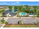 Community clubhouse and pool featuring modern architecture near a serene pond and residential homes at 112 Serenata Dr, Holly Springs, NC 27540