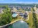 Aerial view showcasing community pool, clubhouse, and scenic pond at 112 Serenata Dr, Holly Springs, NC 27540