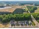 New construction homes with well-manicured lawns in a scenic community with a pond and wooded area at 112 Serenata Dr, Holly Springs, NC 27540