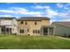 Back exterior of the home with a screened porch overlooking a manicured lawn at 112 Serenata Dr, Holly Springs, NC 27540