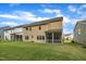 Back exterior view features a fenced yard and screened-in porch at 112 Serenata Dr, Holly Springs, NC 27540