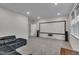 Basement movie room with a large screen, comfortable seating, and a carpeted floor at 112 Serenata Dr, Holly Springs, NC 27540