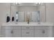 Bright bathroom featuring a double vanity with elegant fixtures, large mirrors, and plenty of counter space at 112 Serenata Dr, Holly Springs, NC 27540