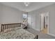 Comfortable bedroom featuring a large window and a door to another room at 112 Serenata Dr, Holly Springs, NC 27540