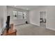 Bedroom featuring carpet, a view of the windows, and a door to the hallway at 112 Serenata Dr, Holly Springs, NC 27540