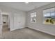 Spacious bedroom with two windows that let in plenty of natural light at 112 Serenata Dr, Holly Springs, NC 27540