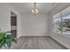 Spacious dining room featuring wood floors and natural light from a large window at 112 Serenata Dr, Holly Springs, NC 27540