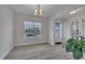 Bright dining room boasts hardwood floors and a modern light fixture at 112 Serenata Dr, Holly Springs, NC 27540