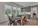 Well-lit dining room featuring modern furnishings and an open view to the outdoors through large windows at 112 Serenata Dr, Holly Springs, NC 27540
