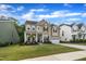 Charming two-story home with a well-manicured lawn, covered porch and attached two car garage at 112 Serenata Dr, Holly Springs, NC 27540