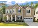 Charming two-story home with a well-manicured lawn, covered porch and attached two car garage at 112 Serenata Dr, Holly Springs, NC 27540