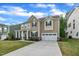 Charming two-story home with a well-manicured lawn, covered porch and attached two car garage at 112 Serenata Dr, Holly Springs, NC 27540
