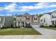 Charming two-story home with a well-manicured lawn, covered porch and attached two car garage at 112 Serenata Dr, Holly Springs, NC 27540