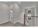 Upper hallway featuring carpet, neutral paint, and a view of the windows at 112 Serenata Dr, Holly Springs, NC 27540