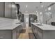 Modern kitchen featuring gray cabinets, white countertops, stainless steel appliances, and hardwood floors at 112 Serenata Dr, Holly Springs, NC 27540
