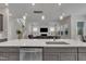 Kitchen island with stainless steel sink and faucet overlooking the living room with fireplace at 112 Serenata Dr, Holly Springs, NC 27540