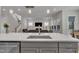Kitchen island with stainless steel sink overlooking the living room and staircase at 112 Serenata Dr, Holly Springs, NC 27540