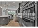 Modern kitchen with stainless steel appliances, gray cabinets, white countertops, and hardwood floors at 112 Serenata Dr, Holly Springs, NC 27540