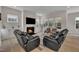 Bright living room boasts recessed lighting, large windows, and stylish furnishings for a cozy atmosphere at 112 Serenata Dr, Holly Springs, NC 27540