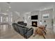 Open living room features a fireplace with a large television and ample modern seating at 112 Serenata Dr, Holly Springs, NC 27540