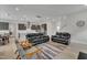 Spacious living room featuring hardwood floors, recessed lighting, and comfortable seating with open access to the kitchen at 112 Serenata Dr, Holly Springs, NC 27540