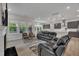 Open concept living room with lots of natural light, neutral tones, and access to dining and kitchen areas at 112 Serenata Dr, Holly Springs, NC 27540