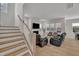 Bright living room featuring a fireplace, large windows, and luxury vinyl flooring at 112 Serenata Dr, Holly Springs, NC 27540