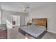 Spacious main bedroom featuring a comfortable bed, ceiling fan, and ensuite bathroom, a private and relaxing space at 112 Serenata Dr, Holly Springs, NC 27540