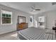 Sunlit main bedroom with a ceiling fan, ensuite bathroom and large windows, creating a bright and airy atmosphere at 112 Serenata Dr, Holly Springs, NC 27540