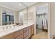 Bright bathroom featuring a dual sink vanity with a walk-in closet for optimal storage solutions at 11470 Club Dr, Chapel Hill, NC 27517