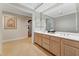 Bathroom featuring double vanity, ample lighting, neutral wall colors, and access to storage spaces at 11470 Club Dr, Chapel Hill, NC 27517
