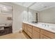 Large bathroom with double vanity, big mirror, modern fixtures, and adjacent toilet room at 11470 Club Dr, Chapel Hill, NC 27517