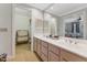 Bathroom featuring double vanity, ample lighting, and access to storage spaces at 11470 Club Dr, Chapel Hill, NC 27517