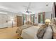 Well-lit bedroom with two beds, a ceiling fan, large windows and traditional decor at 11470 Club Dr, Chapel Hill, NC 27517