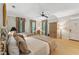 Spacious bedroom with two beds, a ceiling fan, ample natural light, and comfortable accommodations at 11470 Club Dr, Chapel Hill, NC 27517