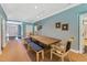 Dining room area featuring large wooden table, comfortable seating, and blue-painted walls at 11470 Club Dr, Chapel Hill, NC 27517