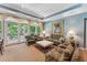 Cozy living area with plush seating, a marble-top table, and French doors leading to a balcony at 11470 Club Dr, Chapel Hill, NC 27517