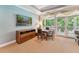 Bright living room features a wall-mounted TV, dining table set, and balcony access at 11470 Club Dr, Chapel Hill, NC 27517