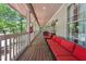 Spacious porch with comfortable seating, railing, and views of the lush surrounding trees at 11470 Club Dr, Chapel Hill, NC 27517