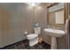 Quaint powder room featuring black and white striped wallpaper and a pedestal sink at 11470 Club Dr, Chapel Hill, NC 27517