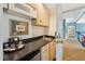 Hallway wet bar featuring sink and mini fridge at 11470 Club Dr, Chapel Hill, NC 27517