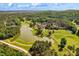 Panoramic aerial showcases golf course, lake, rolling hills and neighborhood, providing endless outdoor enjoyment at 11475 Club Dr, Chapel Hill, NC 27517
