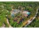 Incredible aerial view of community tennis courts, swimming pool, clubhouse and surrounding tree coverage at 11475 Club Dr, Chapel Hill, NC 27517
